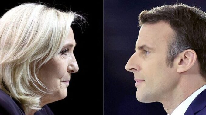 A combination picture shows portraits of Le Pen and Macron running for the second round of the 2022 French Presidential election